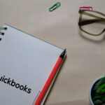 Quickbooks write on a book isolated on Office Desk
