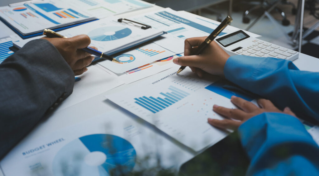 Auditor and accountant team working in office, analyze financial data and accounting record with calculator. Accounting company provide finance and taxation planning for profitable cash flow.