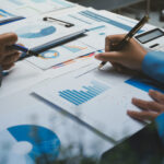 Auditor and accountant team working in office, analyze financial data and accounting record with calculator. Accounting company provide finance and taxation planning for profitable cash flow.